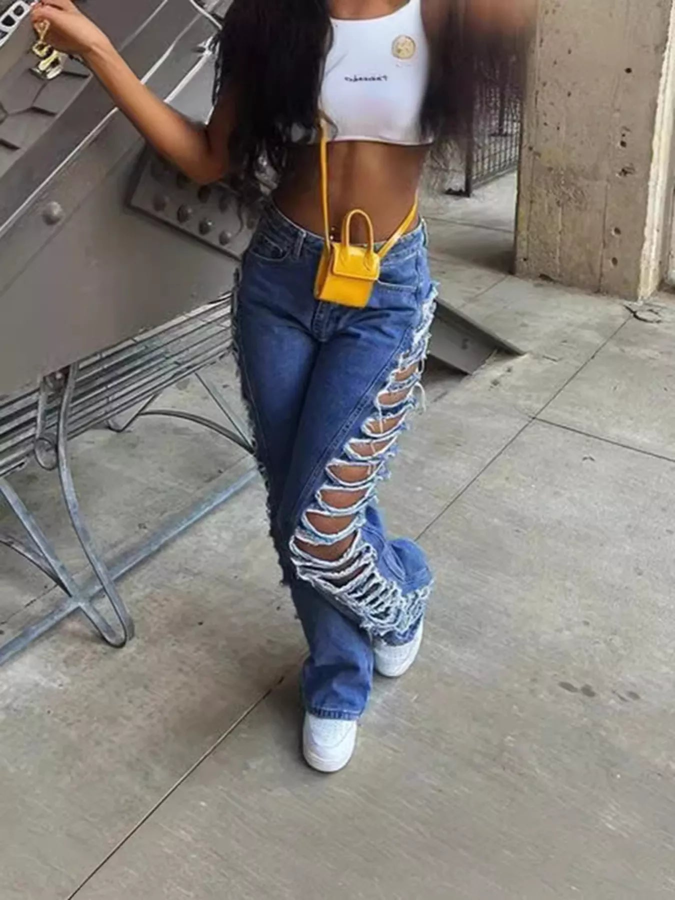 Pair of plush fashion hub side distressed denim jeans showing ripped details and classic fit in a natural pose