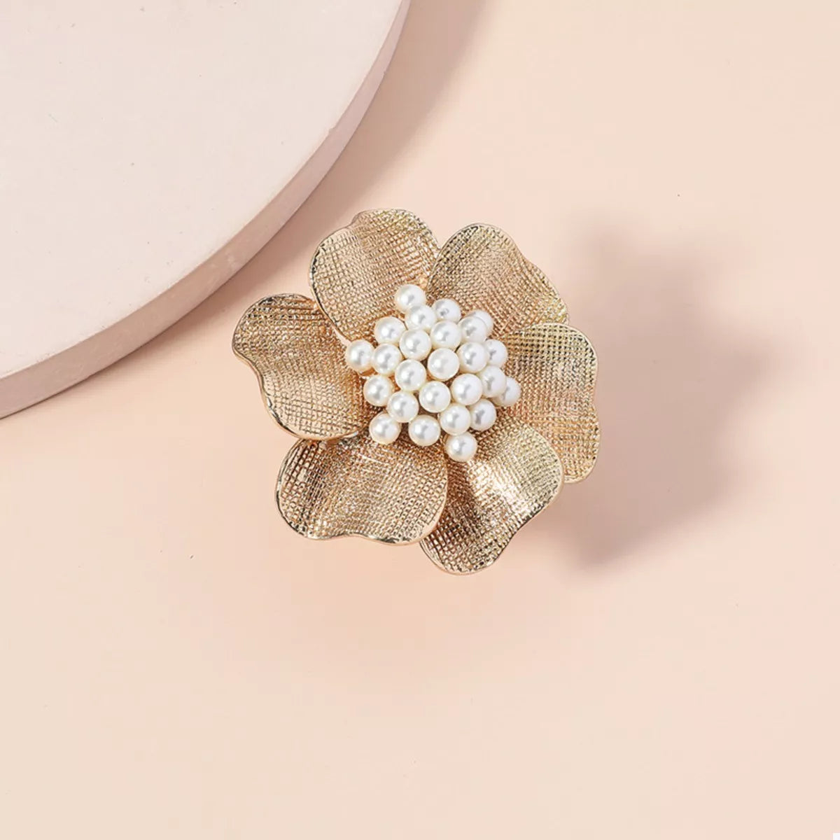 18K gold-plated pearl flower ring showing a delicate pearl flower design on a gold band.