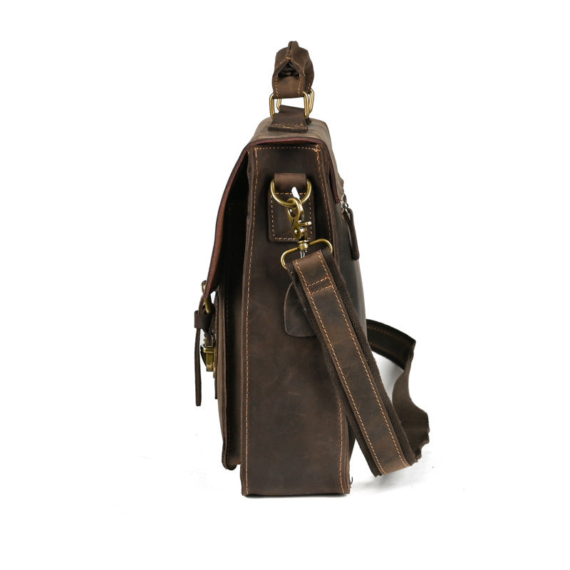 Plush Fashion Hub top layer leather one-shoulder crossbody laptop bag with sleek design and adjustable strap.