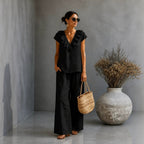 Women's V-neck ruffled hem top and wide-leg pants two-piece casualwear set by Plush Fashion Hub, featuring a stylish, relaxed fit.