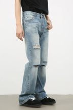 Men's distressed denim jeans by Plush Fashion Shop, showing fit and rips, styled casually on a model.