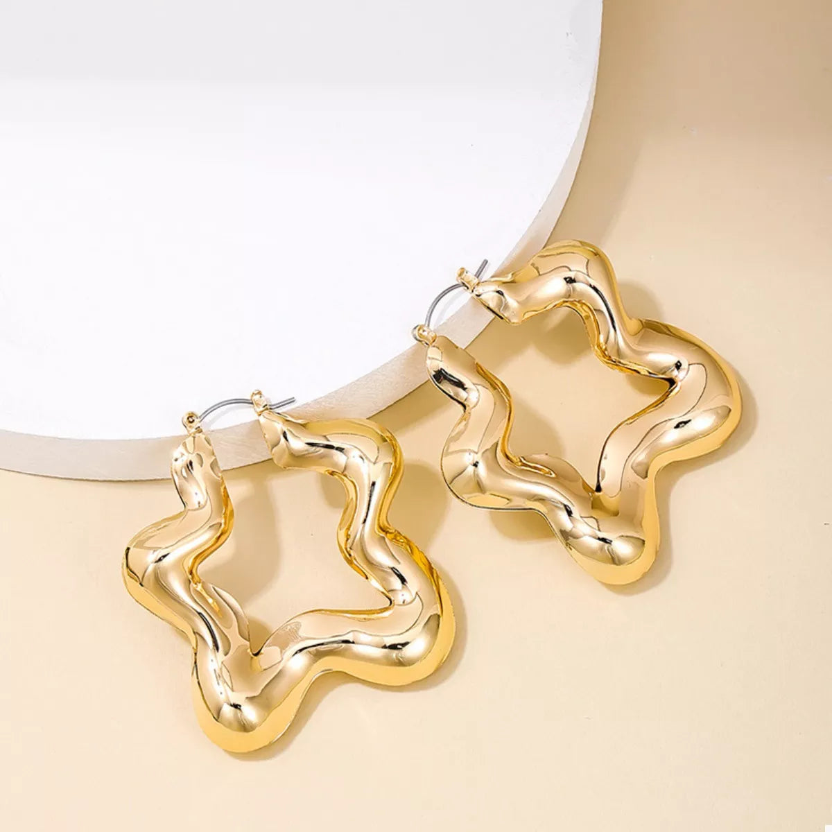 Star-shaped hoop earrings from Plush Fashion Hub featuring shiny metal and a stylish celestial design.