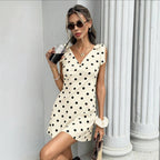 Women's sleeveless V-neck mini dress with lace-up bow detail by FitiqueFit, shown on model with smooth fabric and stylish fit.