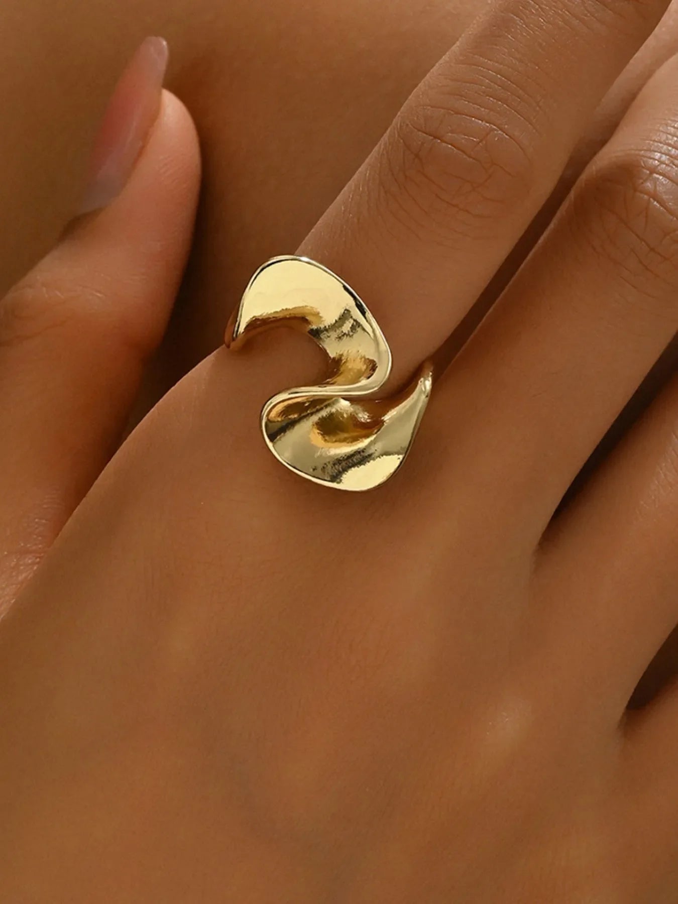 18K gold-plated stainless steel geometric ring with modern design, featuring sleek angular shapes and polished finish.