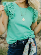 Ruffled eyelet lace cap sleeve top with cutout detail, trendy women's blouse by Trendsi featuring feminine design and intricate lace accents.