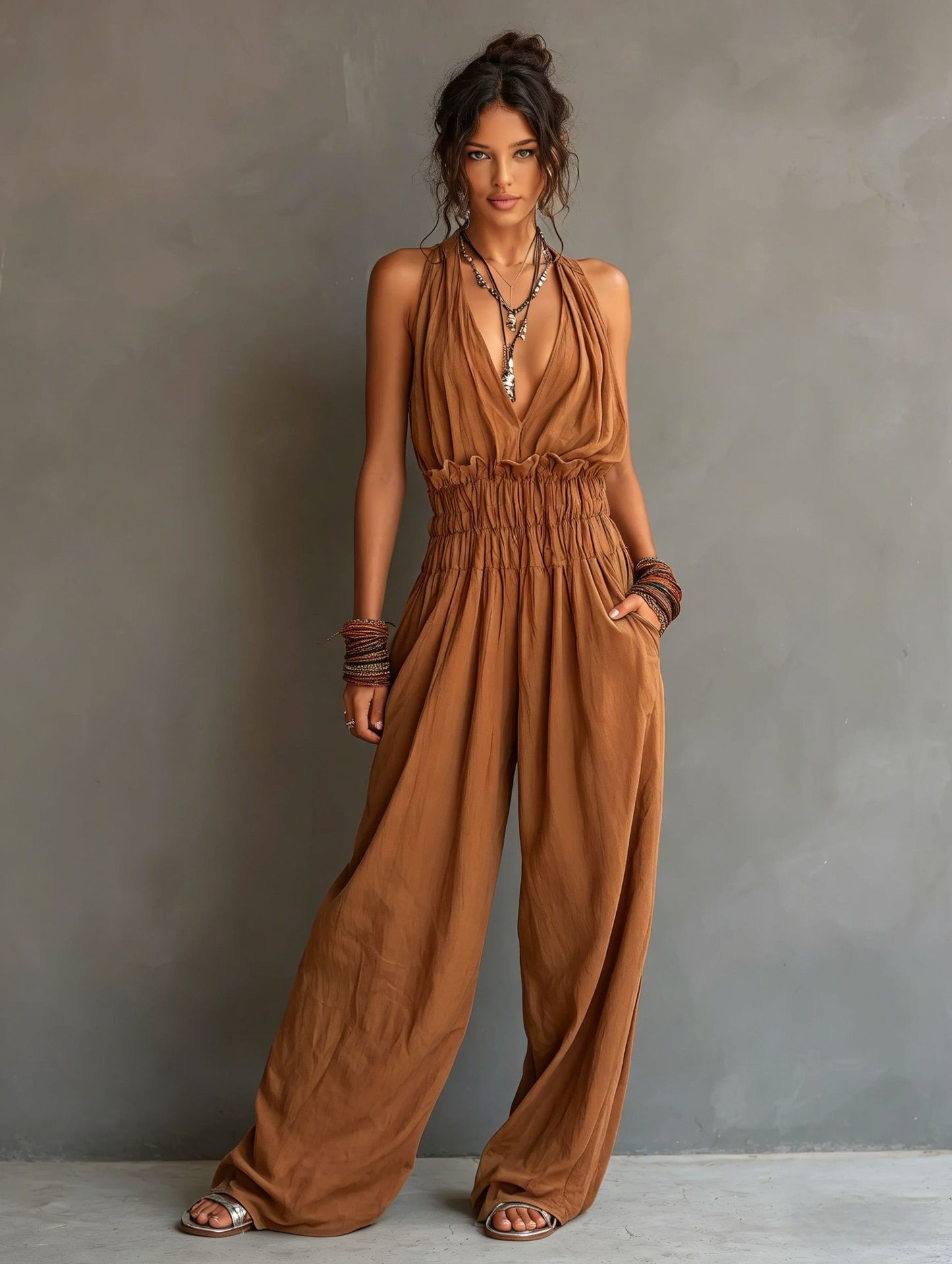 Women's sleeveless V-neck halter jumpsuit with open back and cinched waist by Plush Fashion Hub.