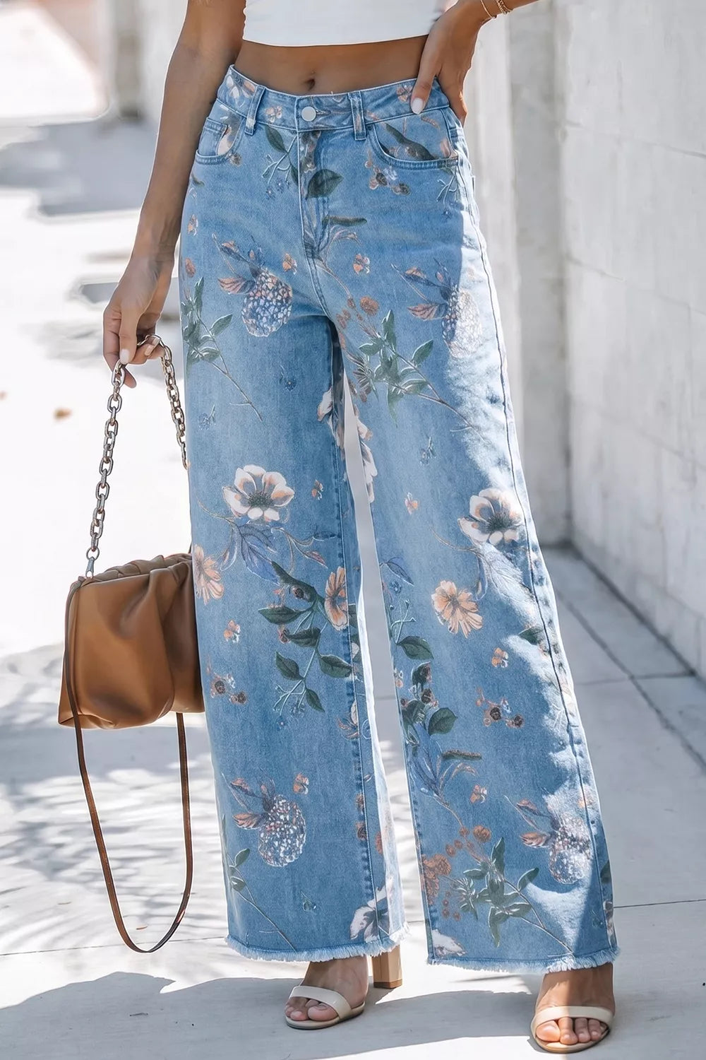 Floral print wide-leg jeans from Trendsi featuring a relaxed fit and vibrant floral pattern on denim fabric.