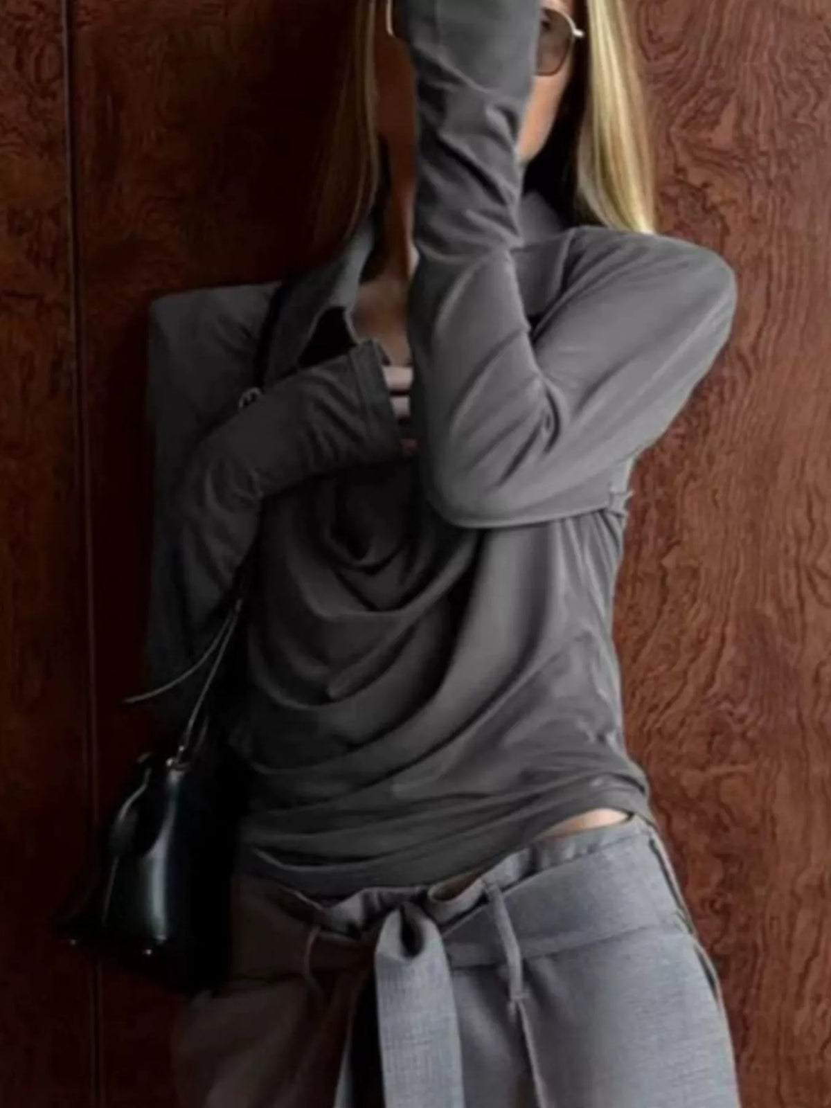Slim-fit long-sleeve T-shirt from Trendsi with stylish cutout detail, black fabric, and modern casual design.