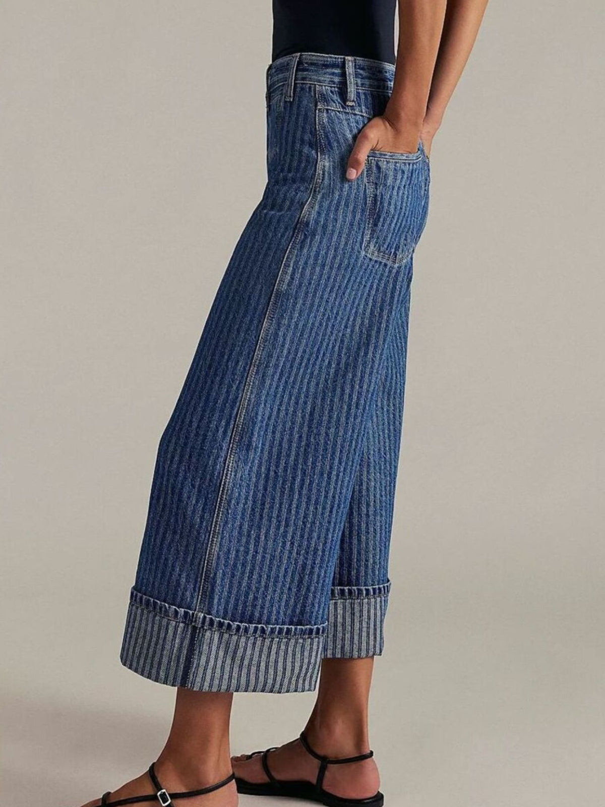 Plush Fashion Hub wide-leg cropped denim jeans displayed on a hanger, showcasing their relaxed fit and classic blue denim fabric.