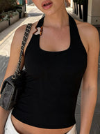 Ribbed halter neck tank top by Shopimist, featuring a fitted design and sleeveless style, shown in a neutral color.