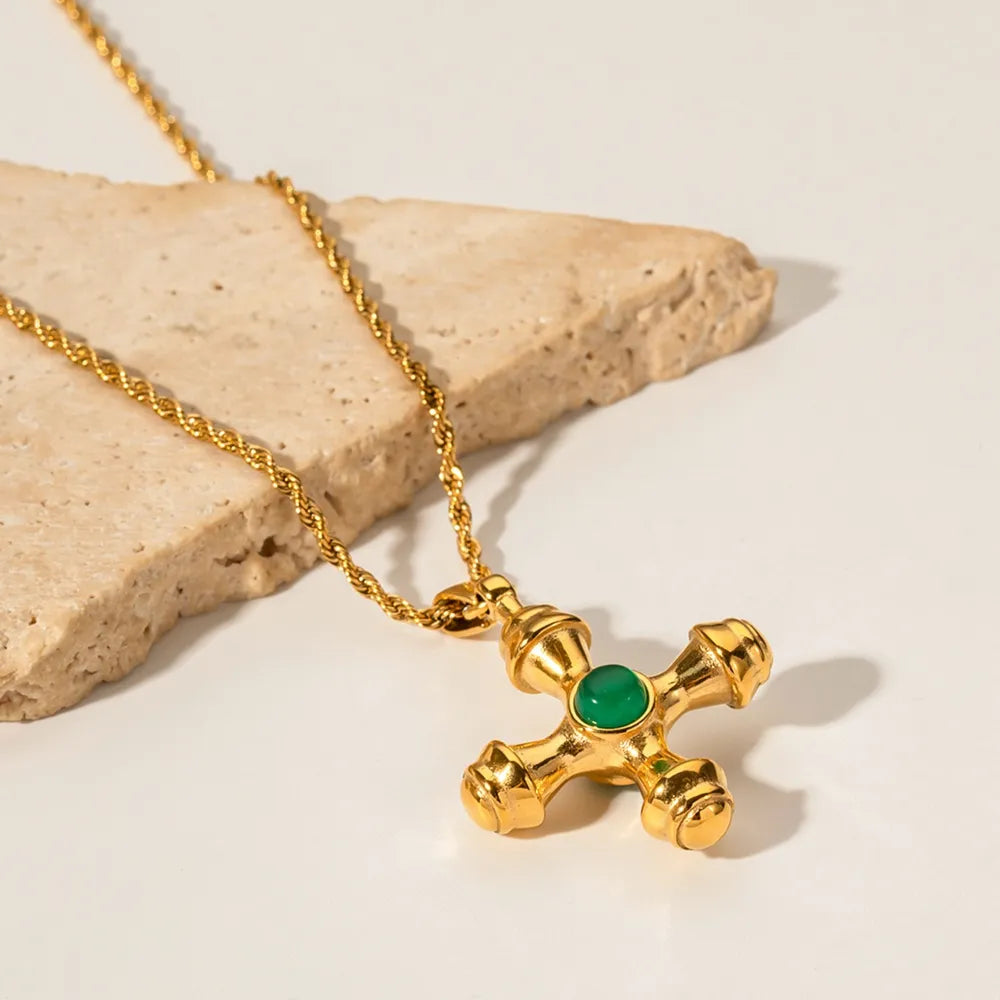 Gold-plated stainless steel cross pendant necklace with detailed cross shape, stylish jewelry piece for women.