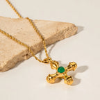 Gold-plated stainless steel cross pendant necklace with detailed cross shape, stylish jewelry piece for women.