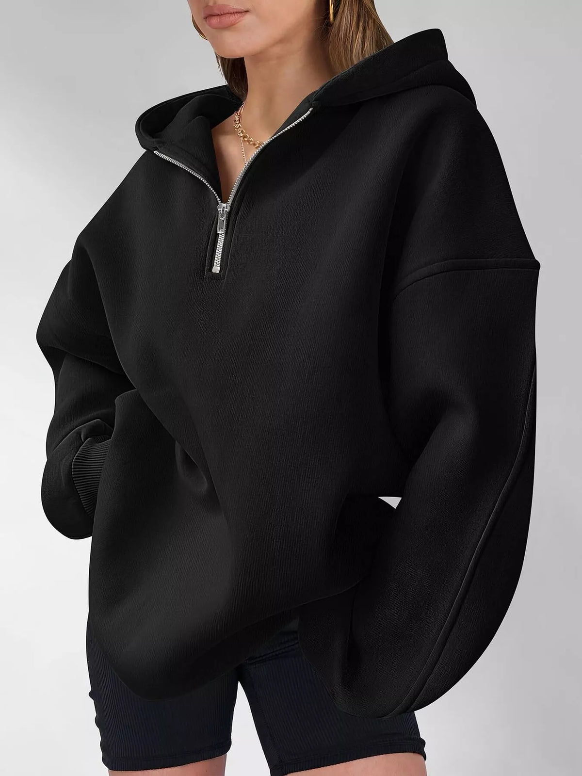 Oversized quarter-zip hoodie from Trendsi, casual tops in soft fabric with a relaxed fit and front quarter zipper.