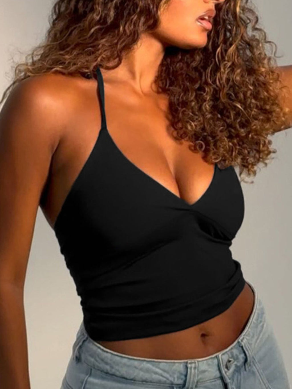 Women's slim fit halter neck cami top from Trendsi featuring sleeveless stretch tank design, perfect for casual summer wear.