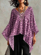 Plus size leopard print asymmetrical hem top by Trendsi, featuring a stylish, flowing design and bold animal print fabric.