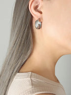 18K gold-plated titanium steel huggie earrings with a smooth, polished finish, designed for a sleek and modern look.