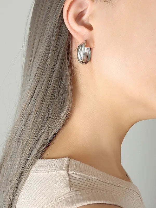 18K gold-plated titanium steel huggie earrings with a smooth, polished finish, designed for a sleek and modern look.