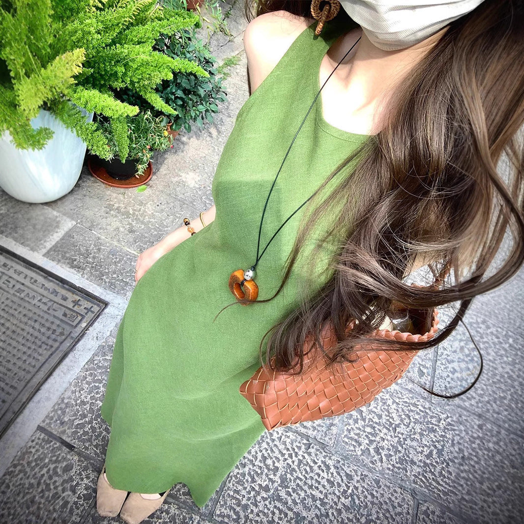 French green sleeveless vest dress by Plush Fashion Hub, shown on a model with a fitted waist and stylish collar detail.
