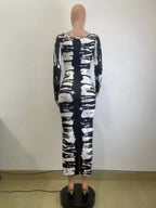 Colorful tie-dye long sleeve maxi dress by Shopimist featuring a flowing design and vibrant patterns.
