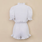 Women's ruffled linen-blend cropped blouse and shorts set by FitiqueFit, featuring lightweight fabric and stylish ruffle details.