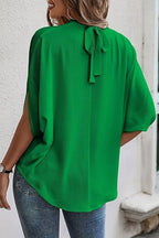 Elegant Plush Fashion Hub tie-back half-sleeve blouse with side slit, featured in this image showing the stylish neckline and relaxed fit.