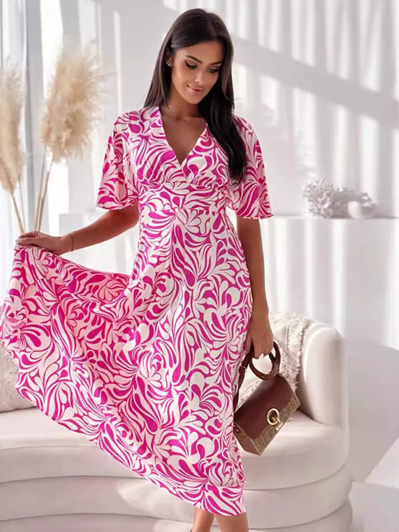 Printed Flutter Sleeve Midi Dress by Plush Fashion Hub featuring a flowing design and vibrant pattern, perfect for elegant occasions.