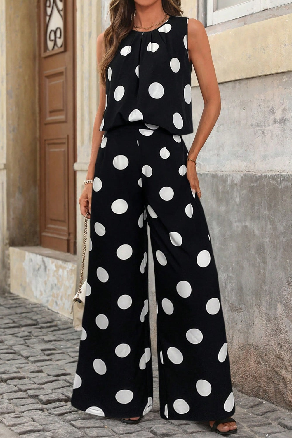 Polka dot sleeveless top and wide-leg pants two-piece set from Trendsi, featuring a stylish sleeveless blouse and flowy pants.