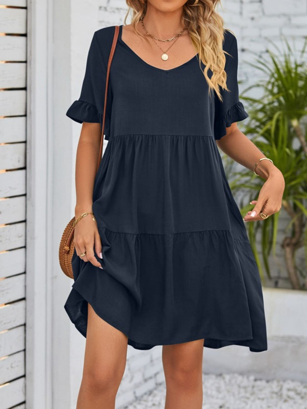 Lightweight rayon ruffled sleeve tiered mini dress with pockets, styled for casual or summer wear.