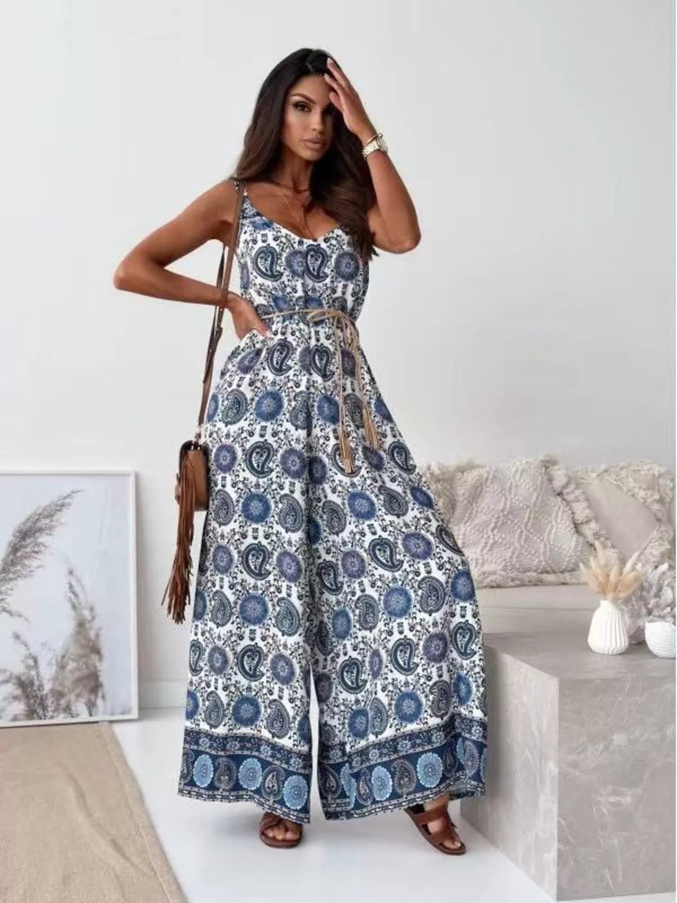 Printed spaghetti strap wide-leg jumpsuit by Plush Fashion Hub, featuring a stylish design and comfortable fit.