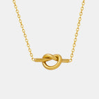 Gold-plated titanium steel knot necklace with a sleek, modern design, featuring a shiny, polished finish.