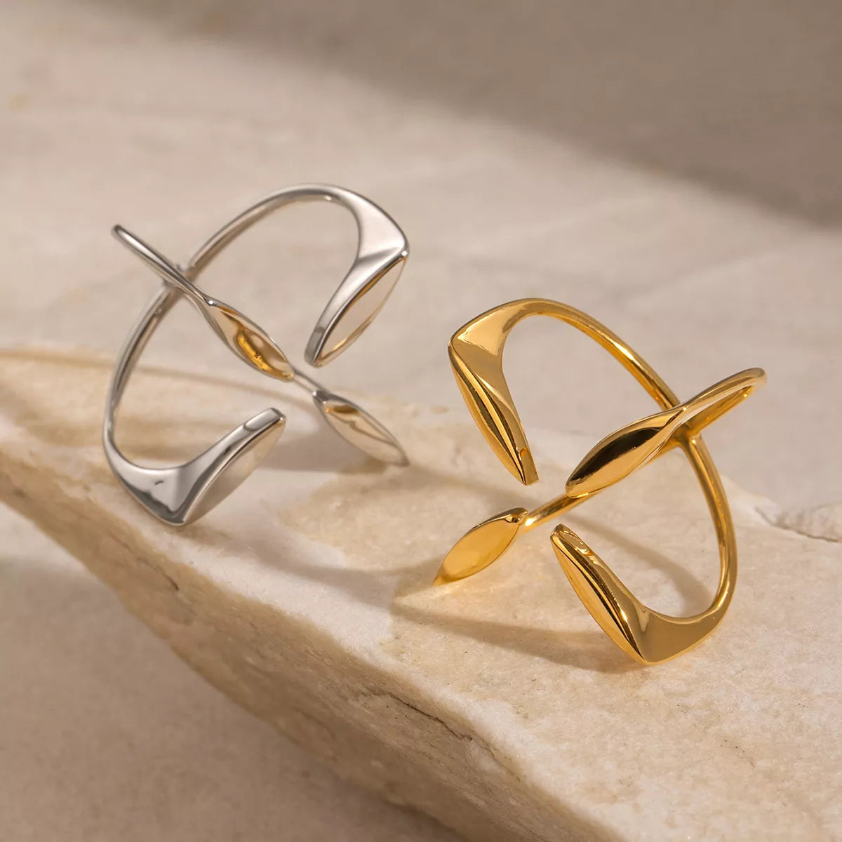 Stainless steel crisscross open ring from Plush Fashion Hub featuring a sleek, modern design with open band and intersecting elements.