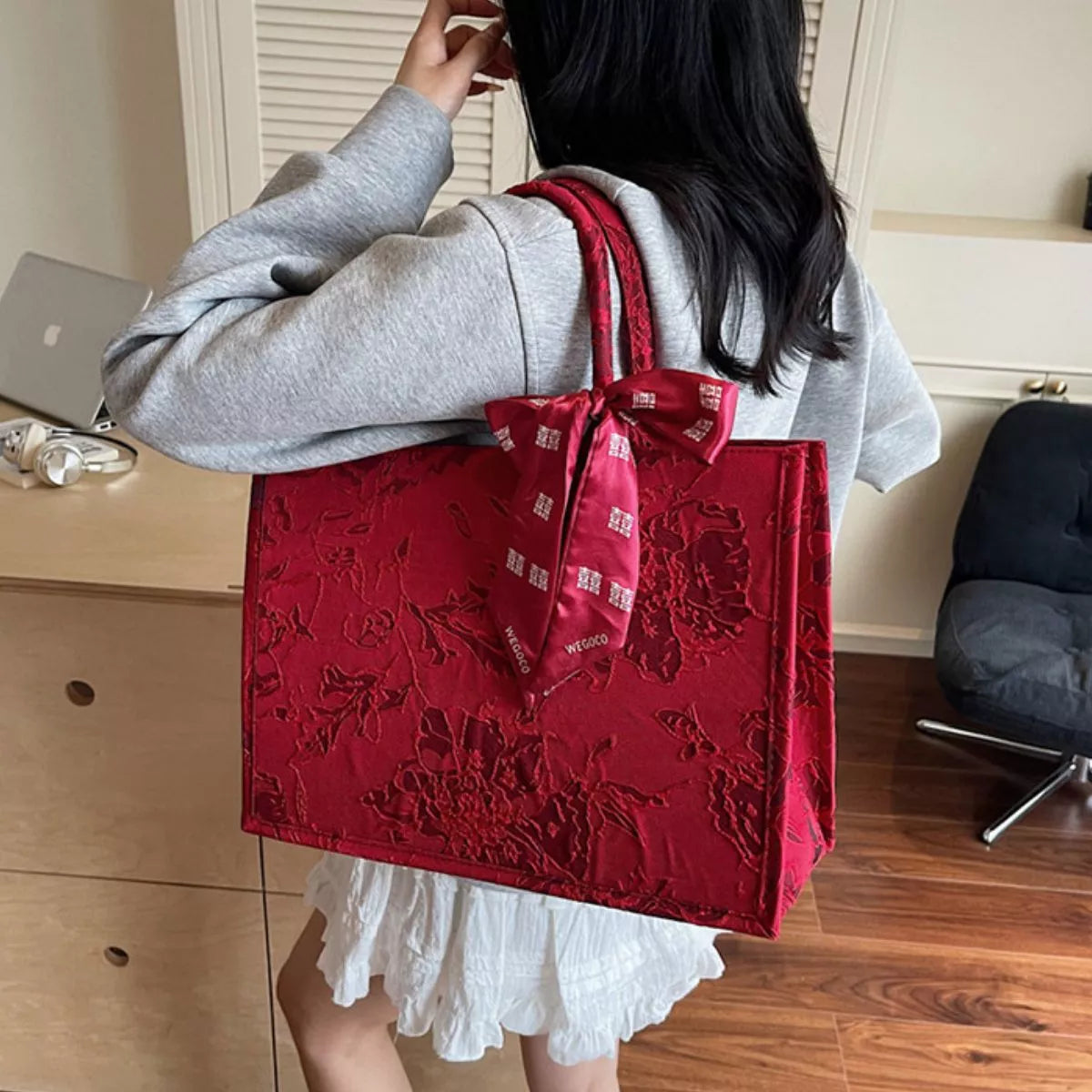 Floral embossed tote handbag by Plush Fashion Hub with scarf accent, featuring structured design and top handles.