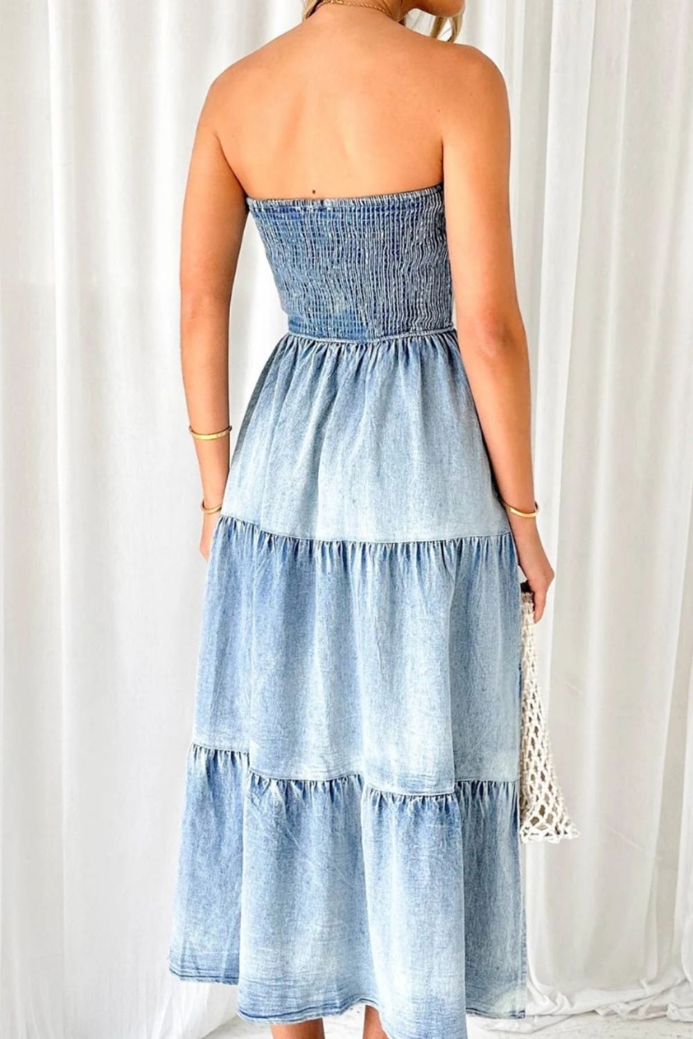 VYSN smocked tube slit tiered denim dress featuring a fitted bodice, tiered skirt, and stylish denim fabric.