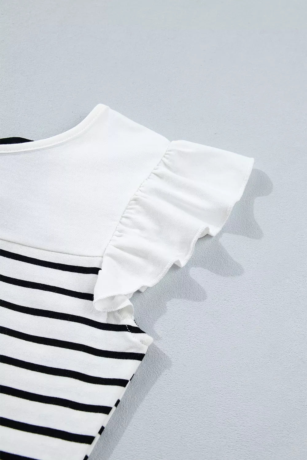 Plush Fashion Hub stripe contrast knot back ruffle trim tank top with sleeveless design and stylish details.