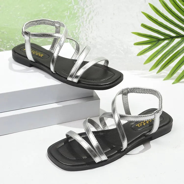 Shopimist crisscross strappy flat sandals with open toe design, featuring multiple straps and a casual slip-on style.