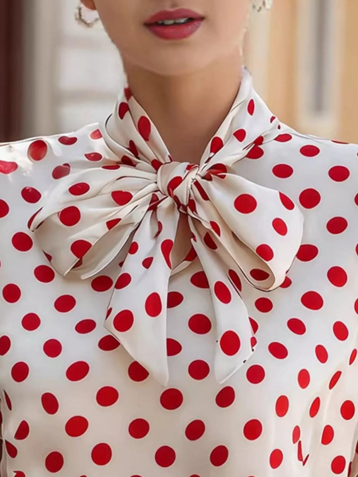 Polka dot tie neck blouse by Plush Fashion Hub, featuring a stylish top with a tie collar and polka dot pattern.
