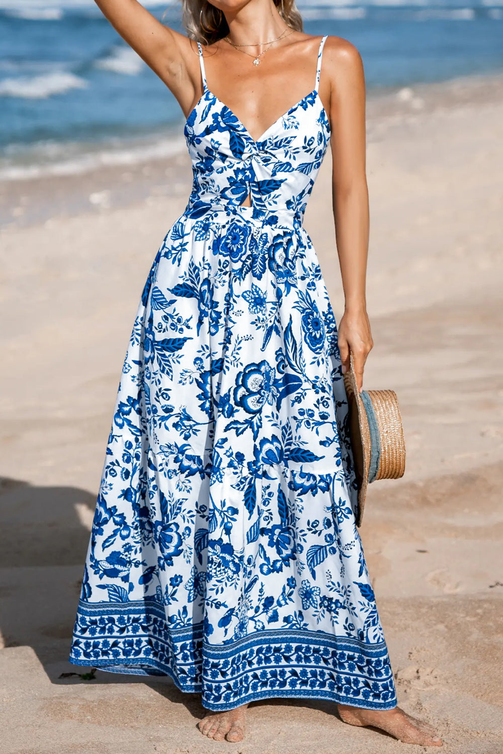 Floral print twisted front backless maxi dress from Trendsi, featuring a cutout back and flowing skirt.