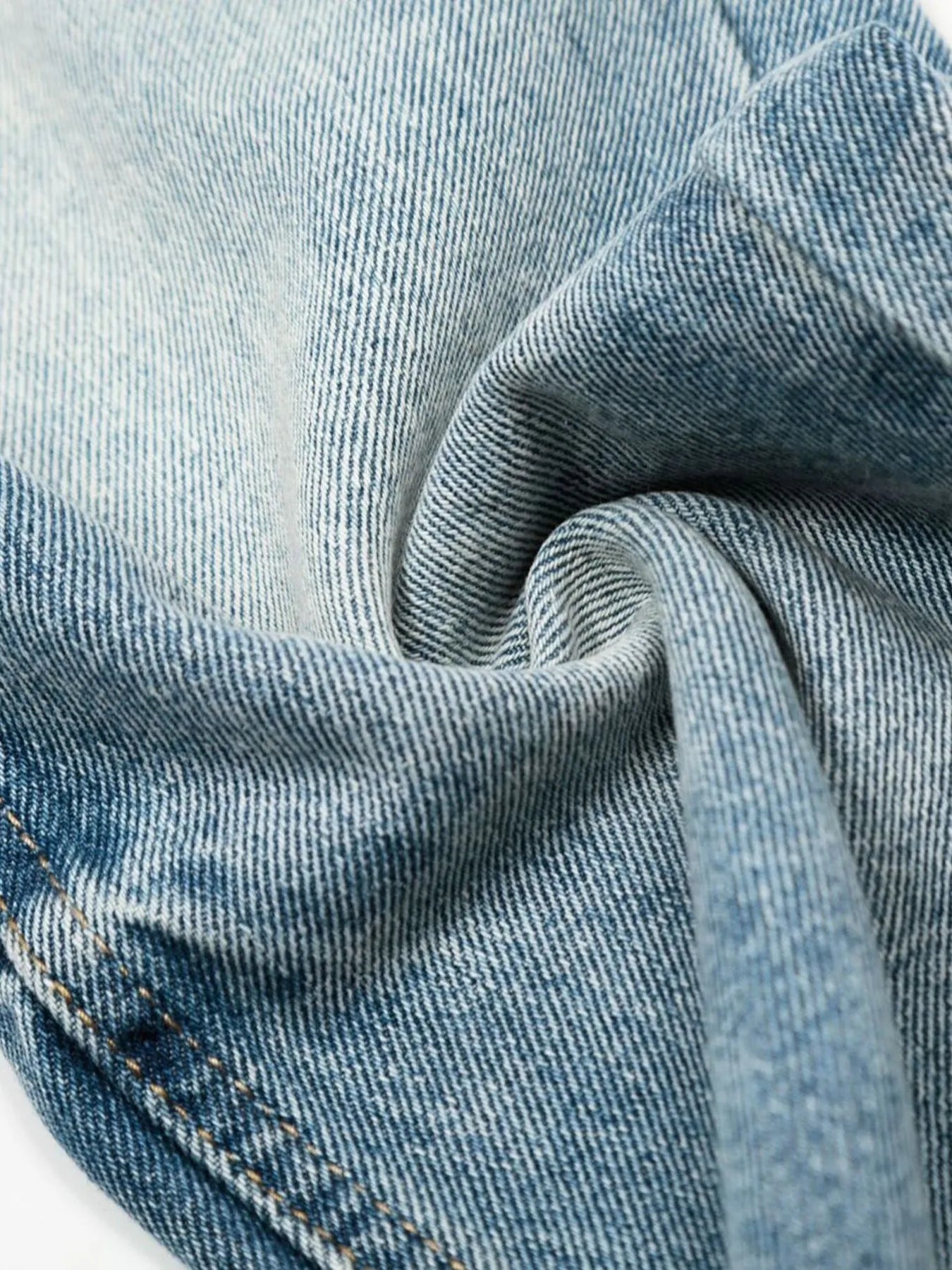 Men's loose fit jeans by Trendsi, displayed on a hanger, showing the casual denim style and classic blue wash.