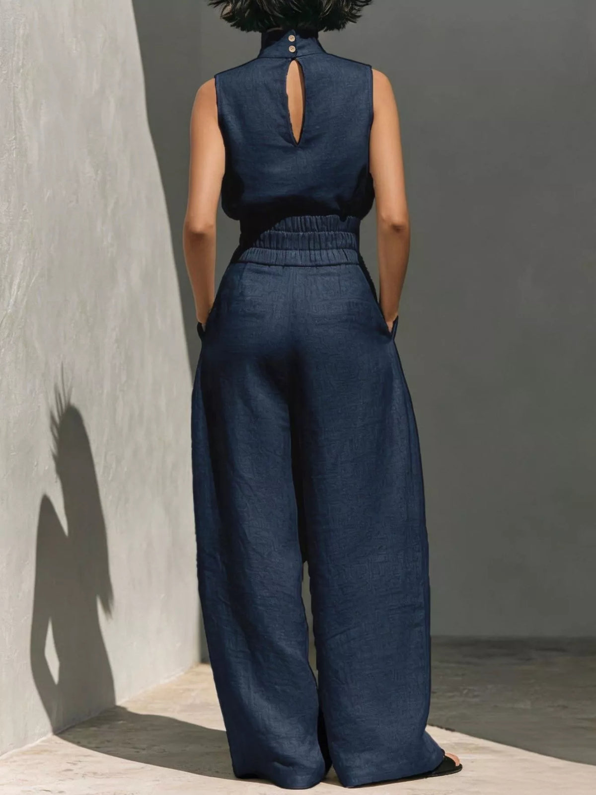 Plush Fashion Hub sleeveless turtleneck top and wide-leg pants set, featuring plush fabric and stylish design, displayed on a model.