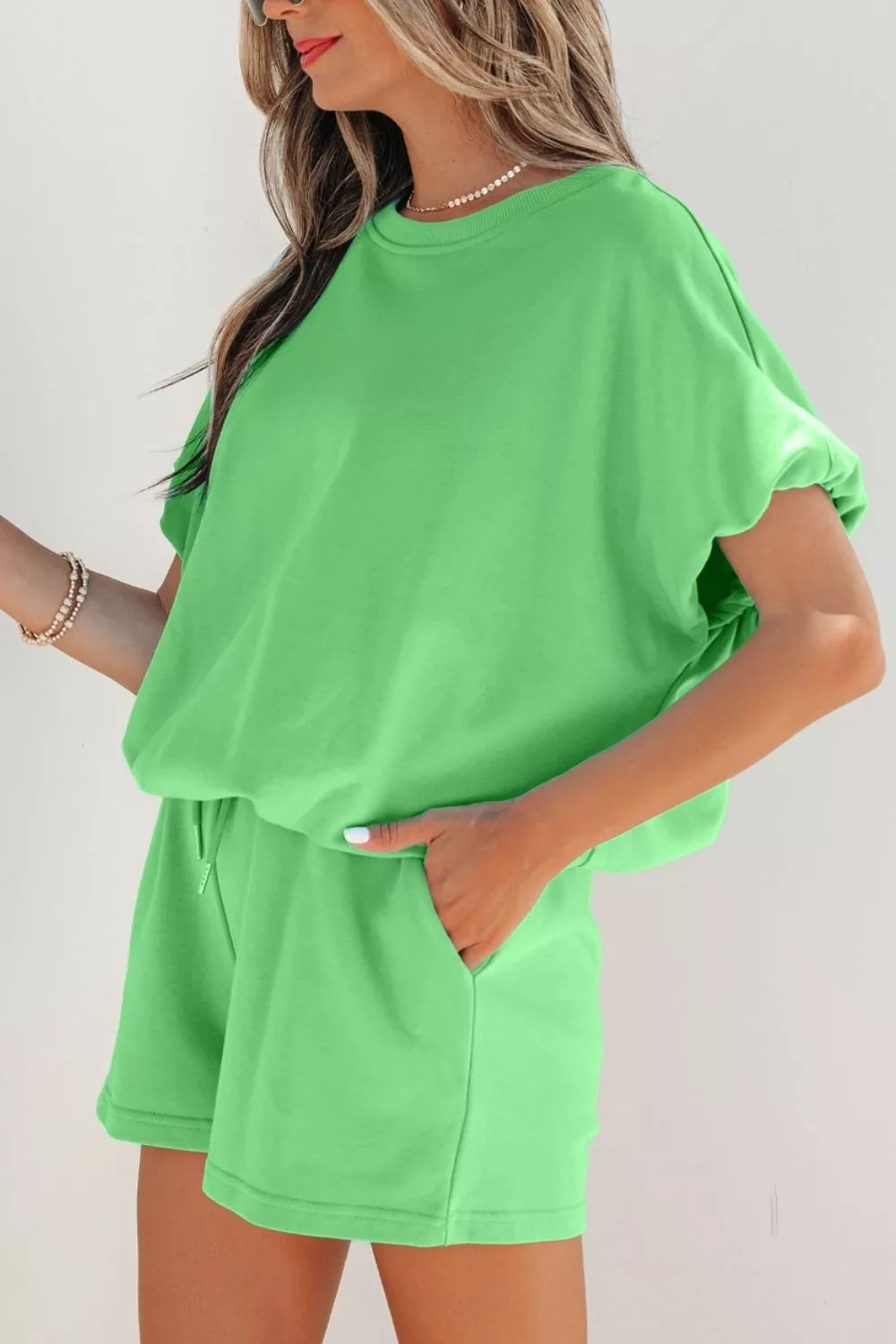 Pair of solid color puffy loose fit drawstring shorts from Trendsi, shown as part of a 2-piece outfit.
