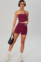 Fitglutes activewear one-shoulder crop top and shorts set, stylish athletic gymwear for workout and sports activities.