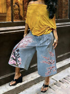 Women's wide-leg cargo pants by Plush Fashion Hub featuring zipper and button details, styled with pockets and relaxed fit.