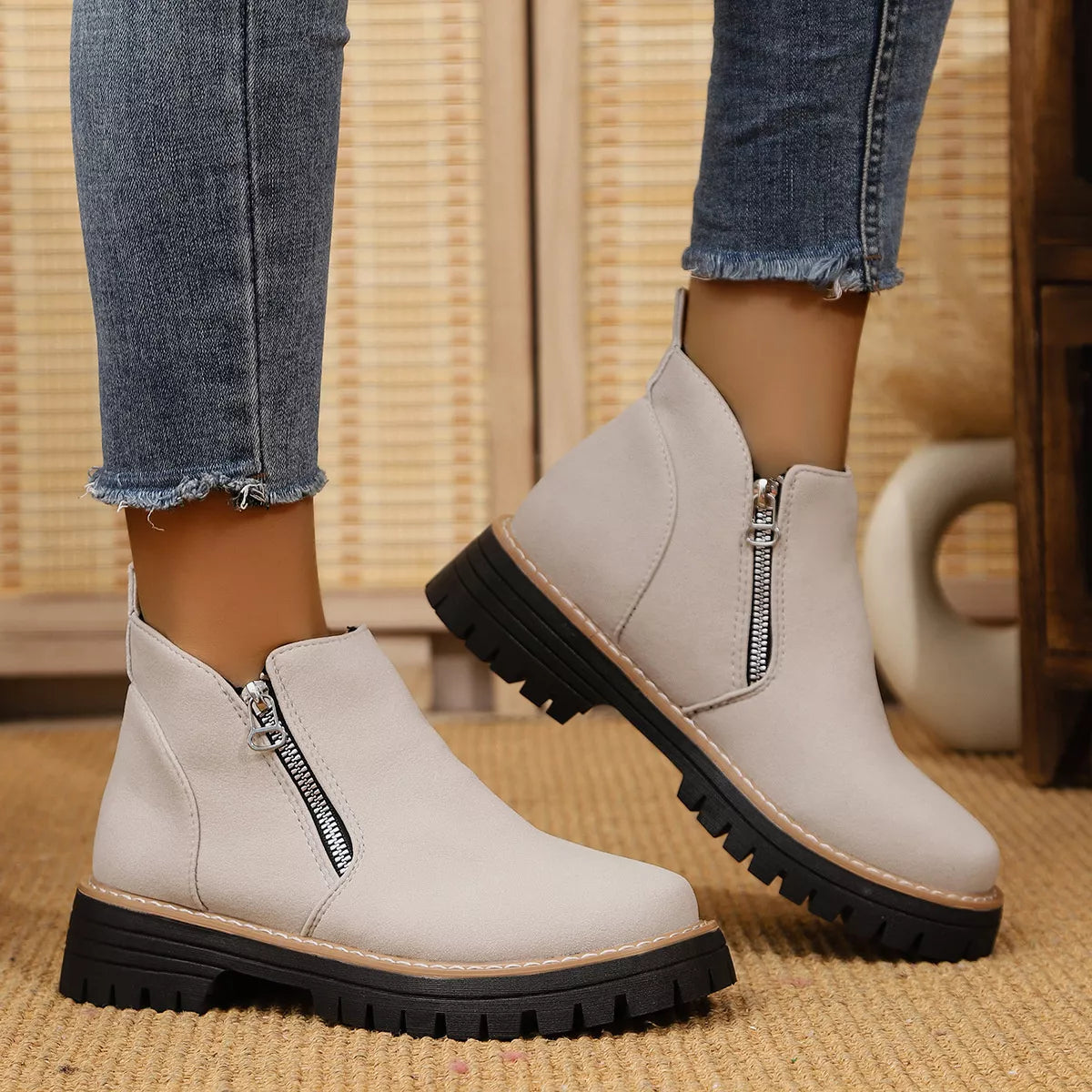 Black ankle boots with zipper accents, trendy footwear by Trendsi featuring sleek design and ankle-height style.