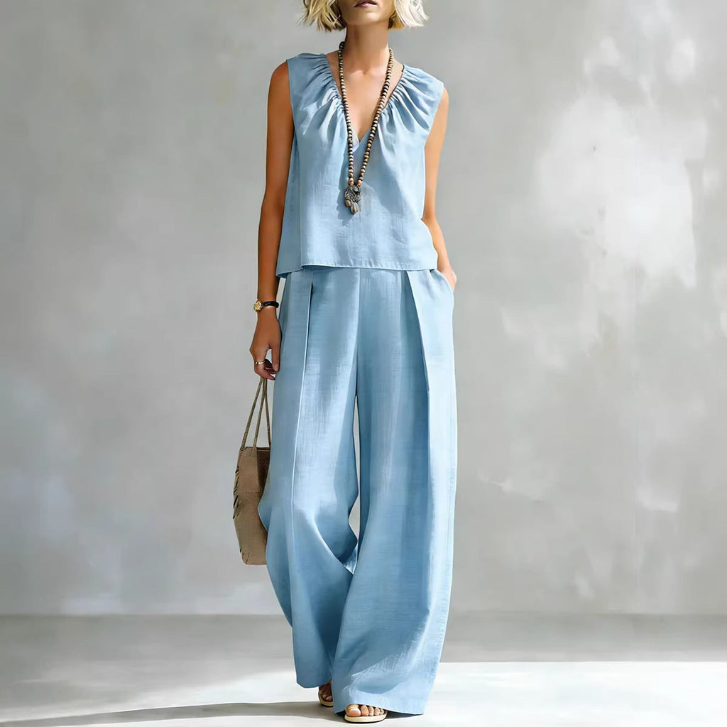 Women's sleeveless cotton-linen shirt and pants set by FitiqueFit, casualwear, laid out flat showing the light, breathable fabric and relaxed fit.