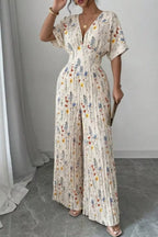 Floral print wide-leg pleated jumpsuit from Trendsi, featuring a flowing silhouette and vibrant floral design.