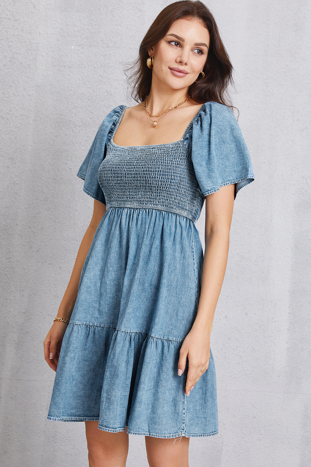 Smocked square neck mini denim dress by Plush Fashion Hub, featuring a fitted bodice and short hemline on model.