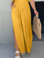 Plus size maxi dress with slit V-neck and smocked waist by Trendsi, featuring flowy fabric and elegant design.