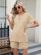 Solid color short sleeve top and shorts two-piece set from Trendsi, casual summer outfit with comfortable fabric and relaxed fit.