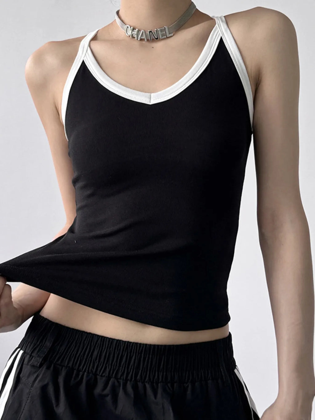 Contrast trim cami top from Trendsi, featuring a sleek design with contrasting details, perfect for casual or layered outfits.