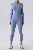 Black half zip mock neck active jumpsuit from Trendsi, featuring a fitted design and breathable fabric for athletic wear.